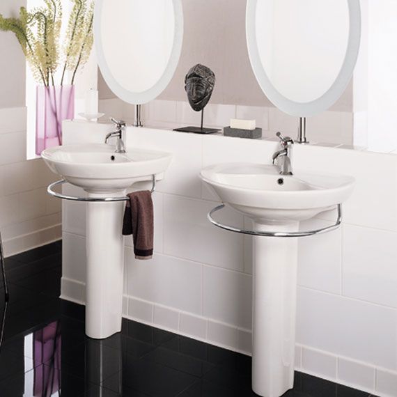 A bathroom with two sinks and two mirrors