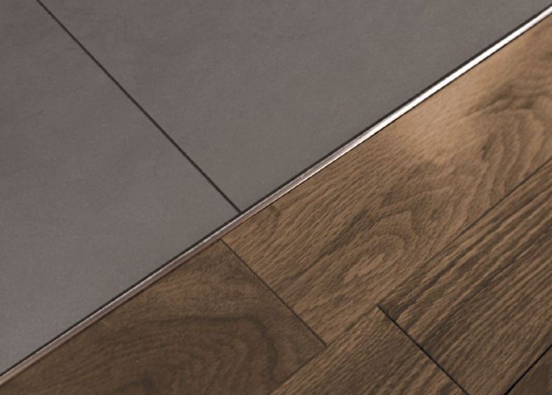 A wooden floor next to a tile floor