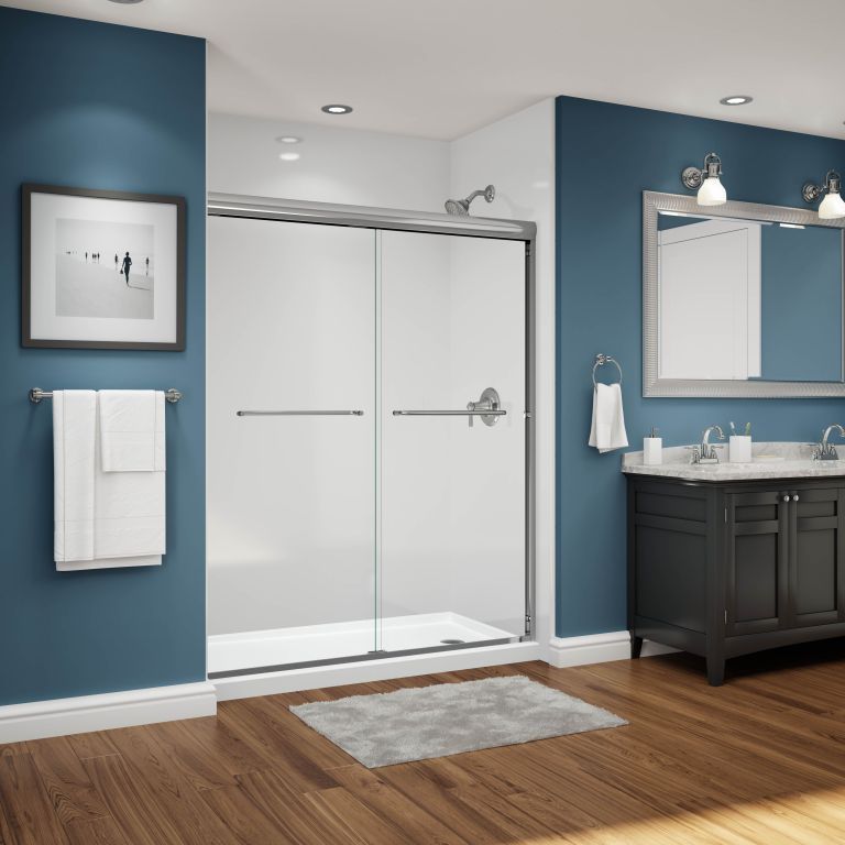 A bathroom with blue walls and a sliding glass shower door