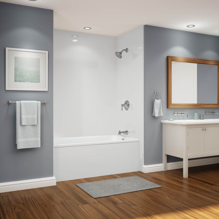 A bathroom with a bathtub a sink and a mirror