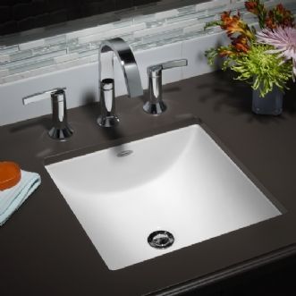 A bathroom sink with a soap bar and flowers on the counter