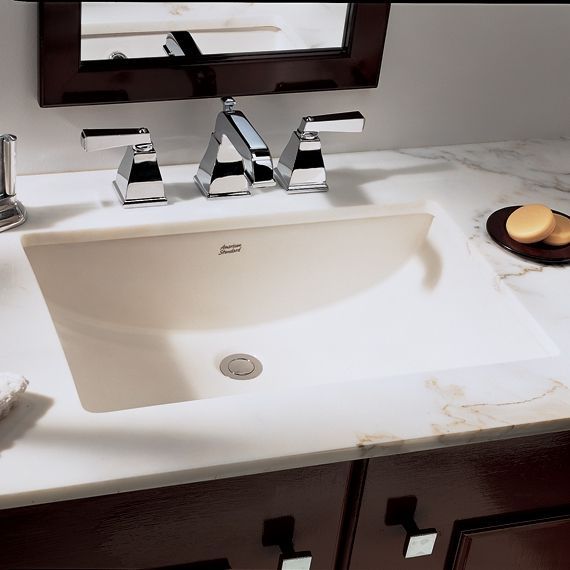 A bathroom sink with a mirror above it