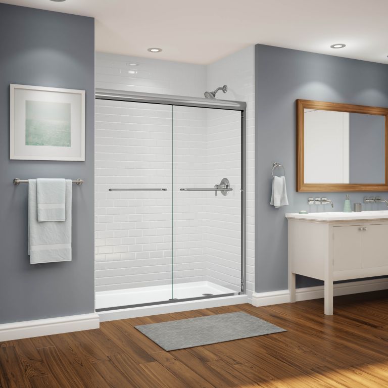 A bathroom with a sliding glass shower door