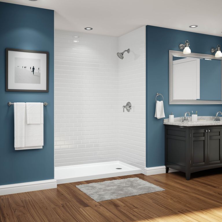 A bathroom with blue walls and a walk in shower