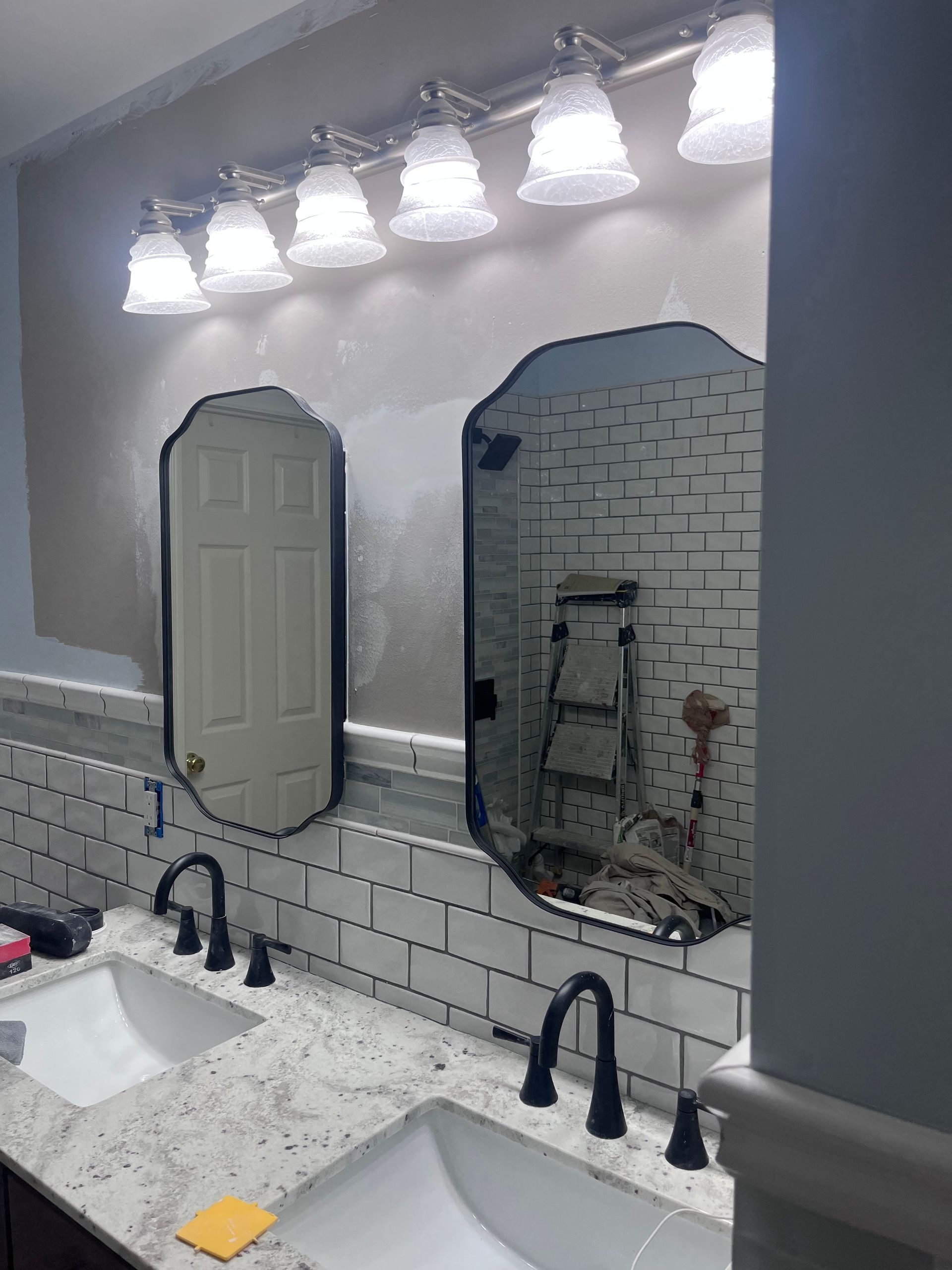 A bathroom with two sinks and two mirrors.