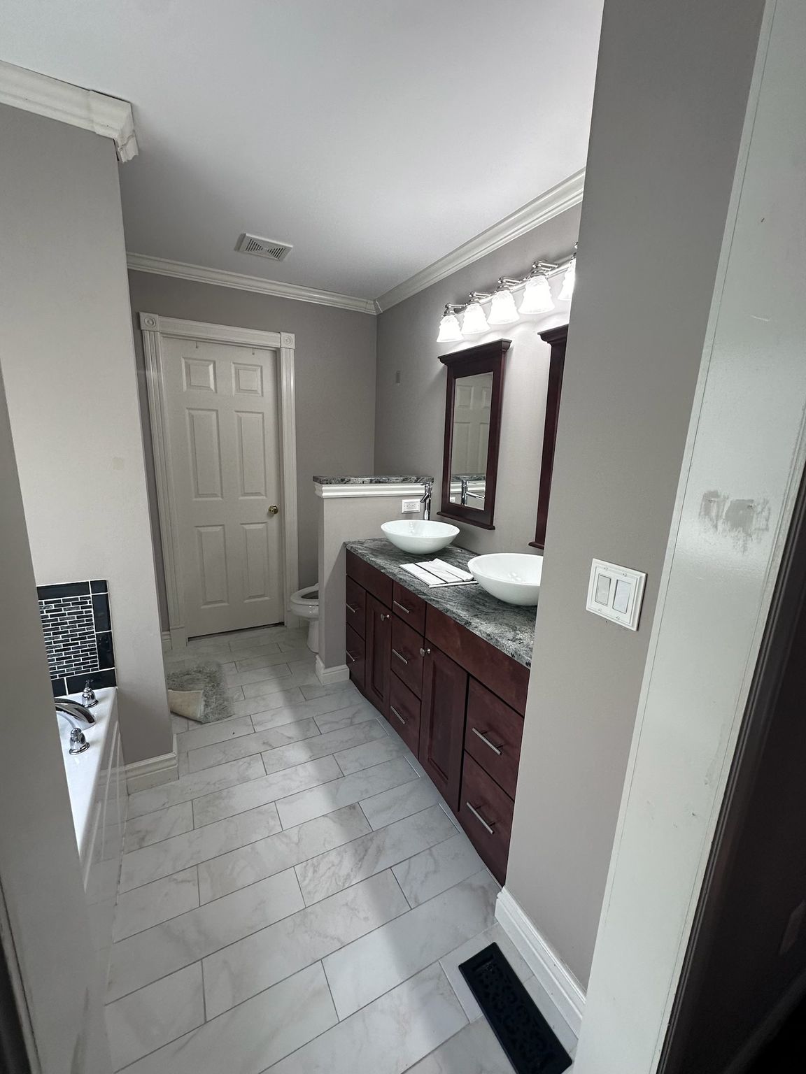 A bathroom with two sinks and two mirrors.