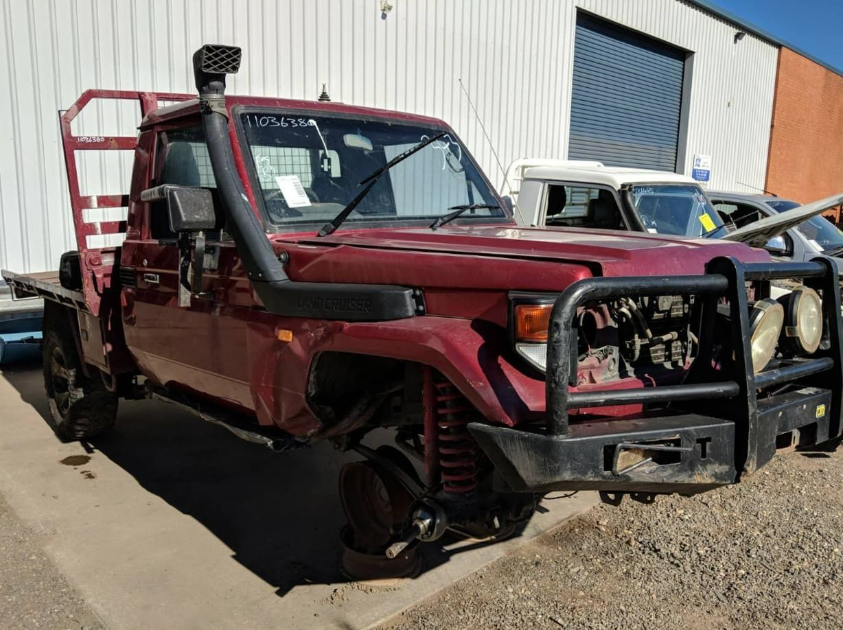 A Red Truck With A Snorkel On Top Of It Is Parked In Front Of A Building — Scott's 4WD Parts Plus In Armidale, NSW