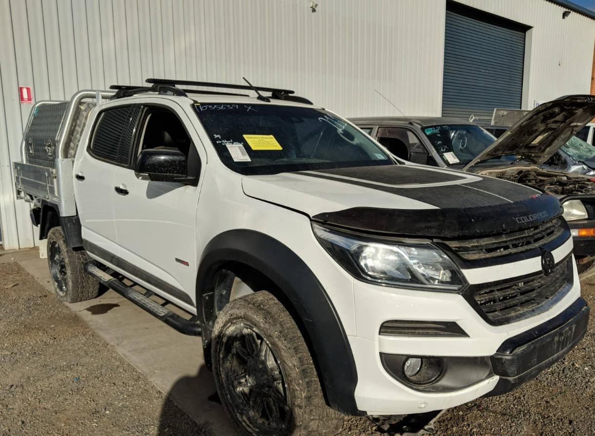 A White Truck Is Parked In Front Of A Building — Scott's 4WD Parts Plus In Parkes, NSW