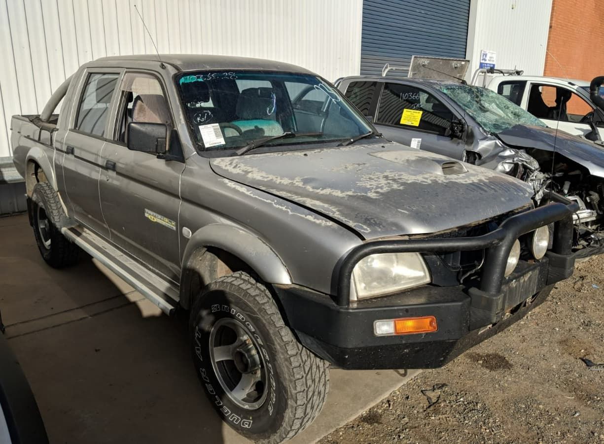A Gray Truck Is Parked In Front Of A Building — Scott's 4WD Parts Plus In Parkes, NSW