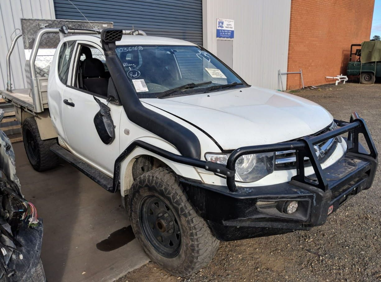 A White Truck With A Snorkel Is Parked In Front Of A Building — Scott's 4WD Parts Plus In Dubbo, NSW
