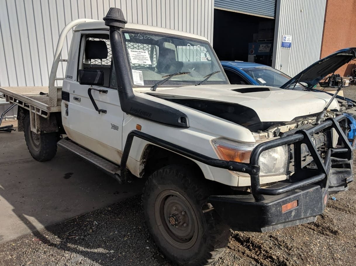 A White Truck With The Hood Up Is Parked In Front Of A Building — Scott's 4WD Parts Plus In Dubbo, NSW