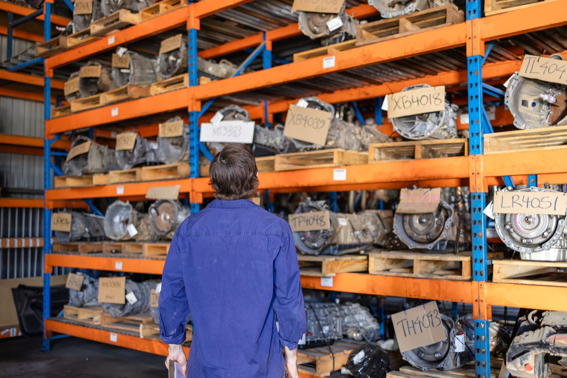 Heavy orange shelves with mechanical parts— Scott's 4WD Parts Plus In Dubbo, NSW