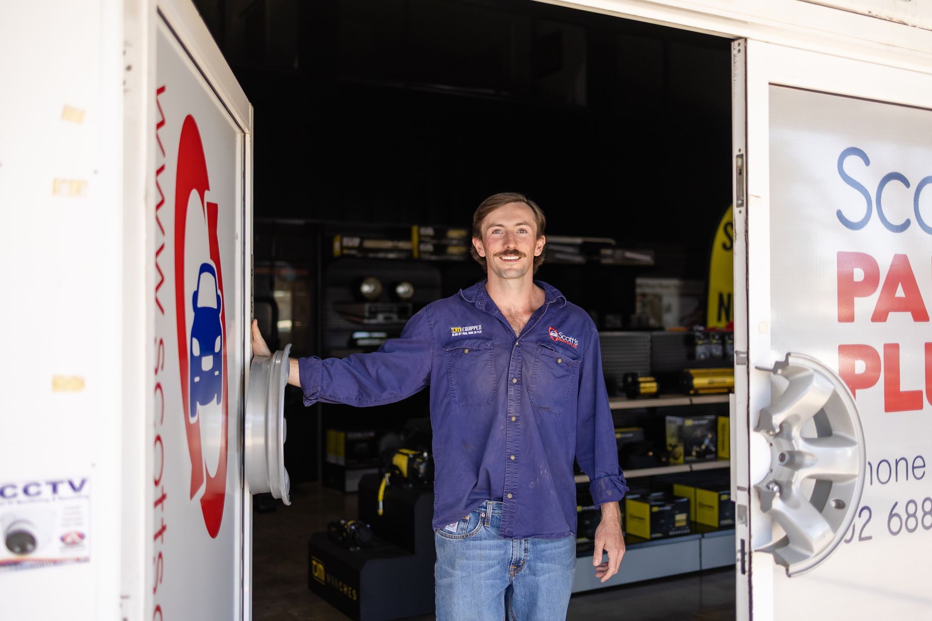 Man in blue dust jacket at the front door— Scott's 4WD Parts Plus In Dubbo, NSW