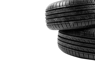 Two black car tires stacked against a white background. | Mike's Garage CC