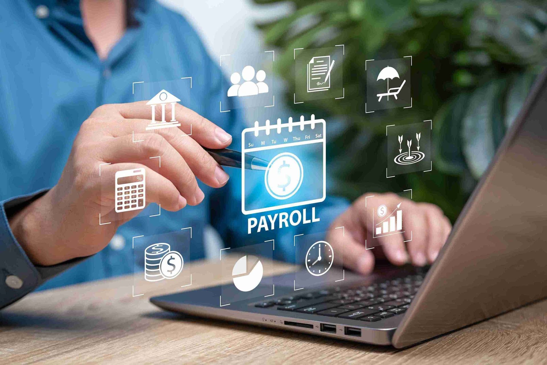 Hands typing on laptop with glowing payroll icon and finance symbols overlayed