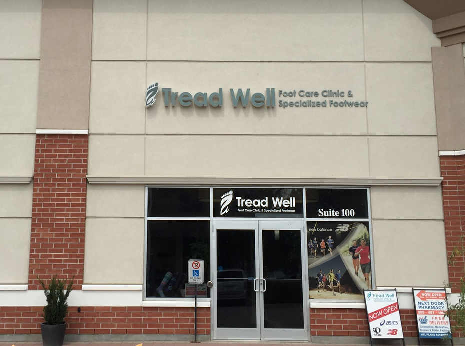 Tread Well foot care clinic storefront with glass doors and window signs in a strip mall
