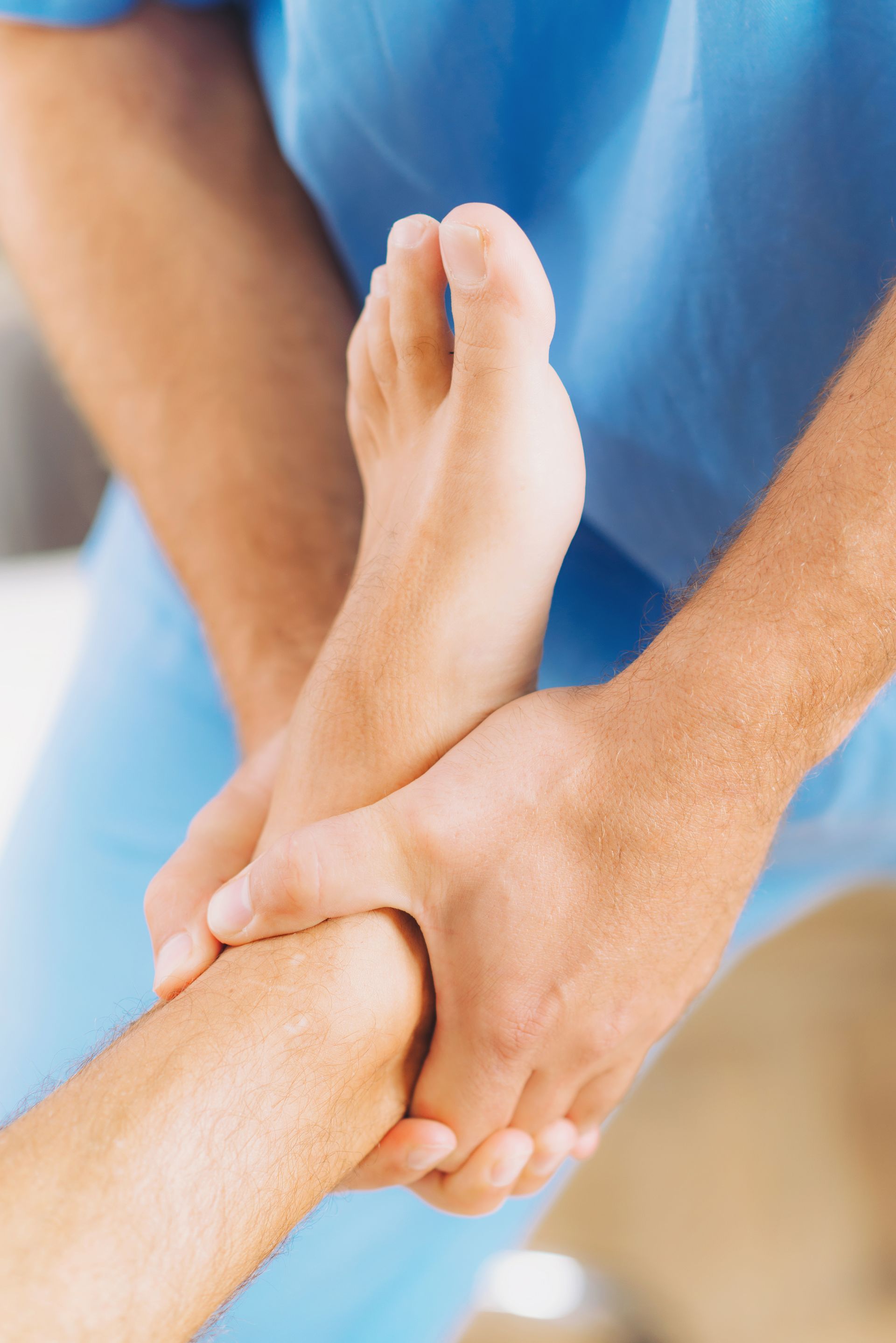 A person is getting a foot massage from a doctor.