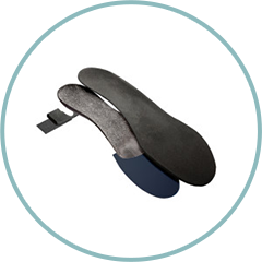 A pair of black insoles in a circle on a white background