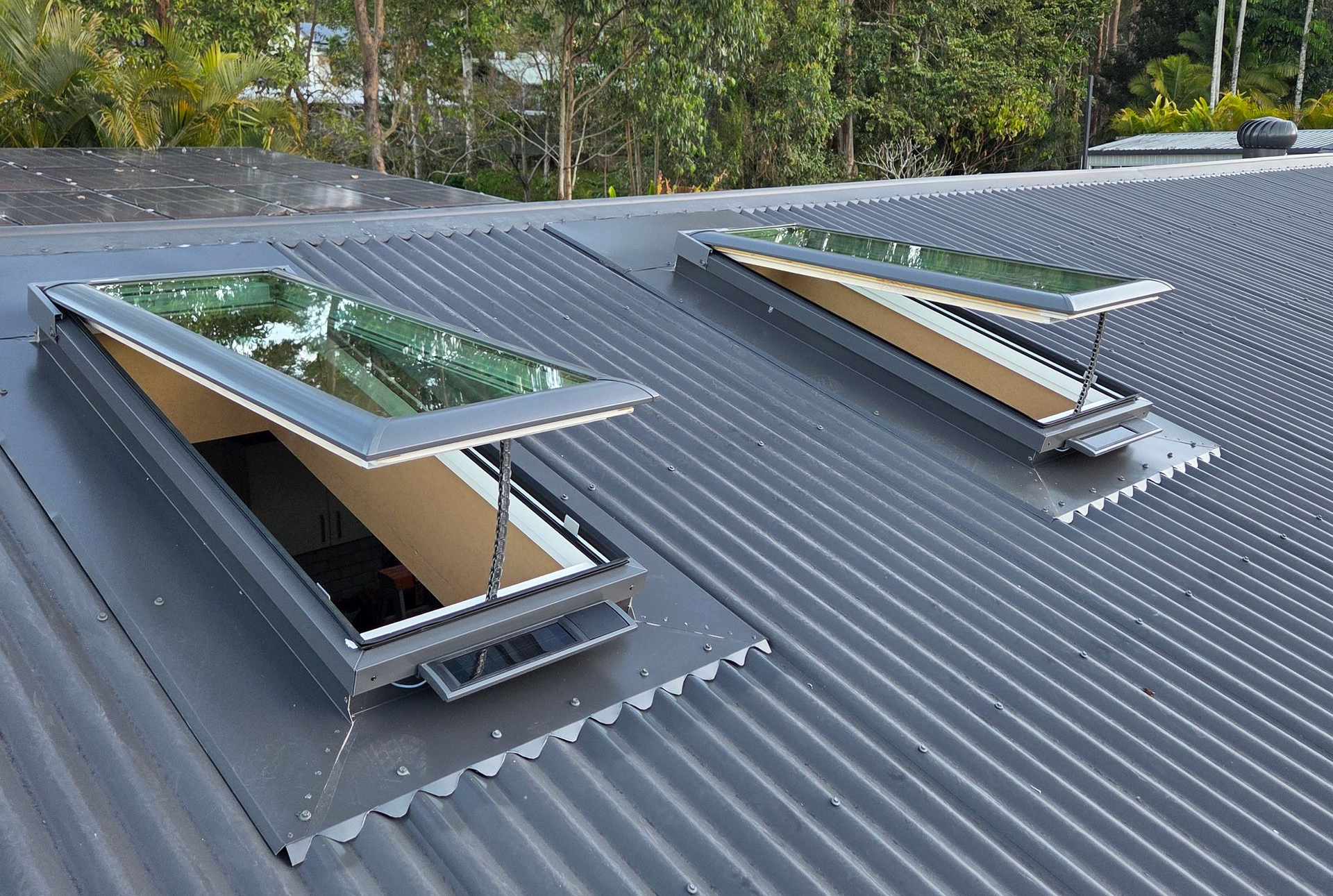 Two Solar Skylights on a Corrugated Metal Roof With Trees in the Background — Beyond Skylights in Byron Bay, NSW