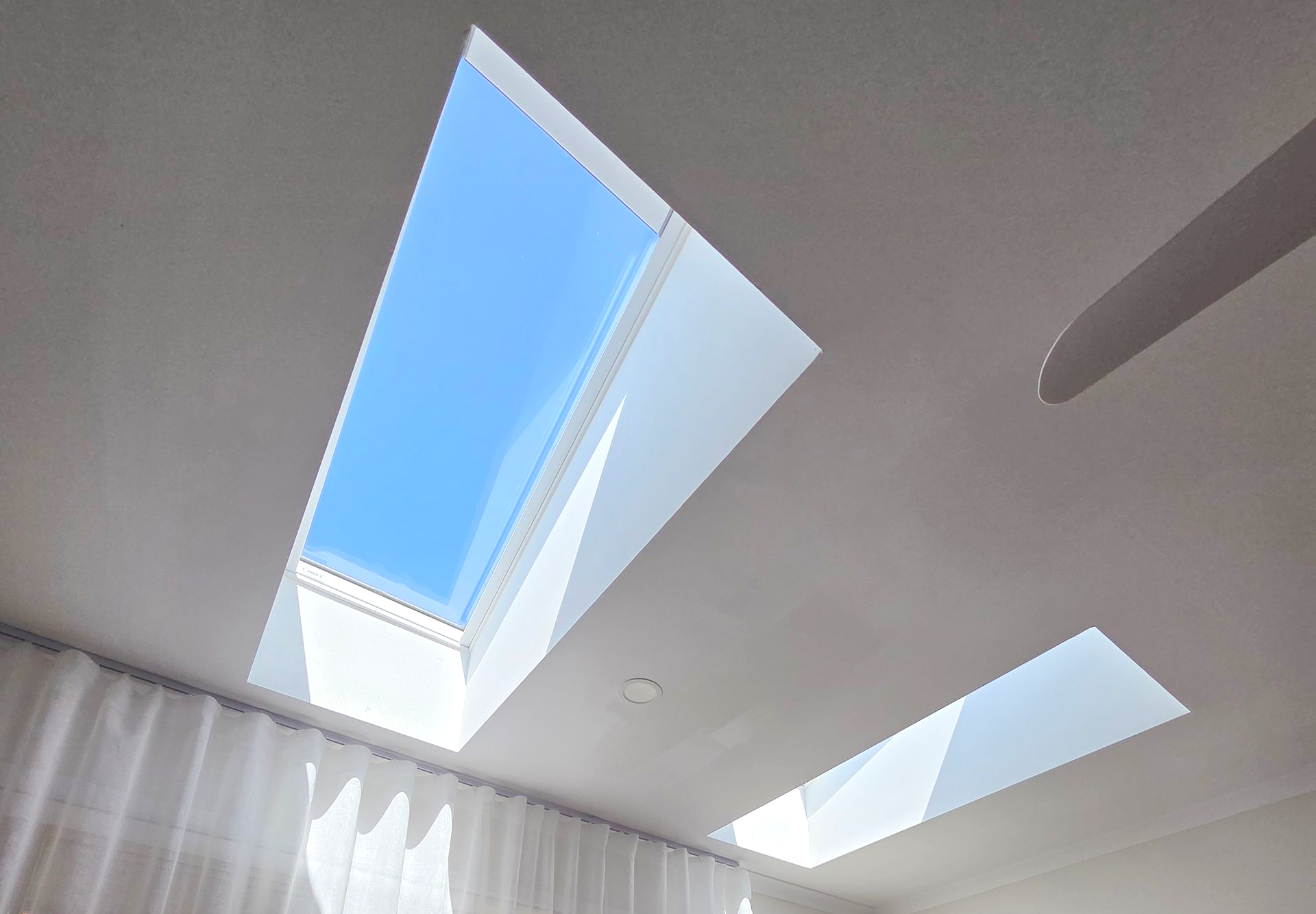 Sunlit Room With Two Skylights, Sheer Curtains, and a Small Table in the Corner — Beyond Skylights in Byron Bay, NSW