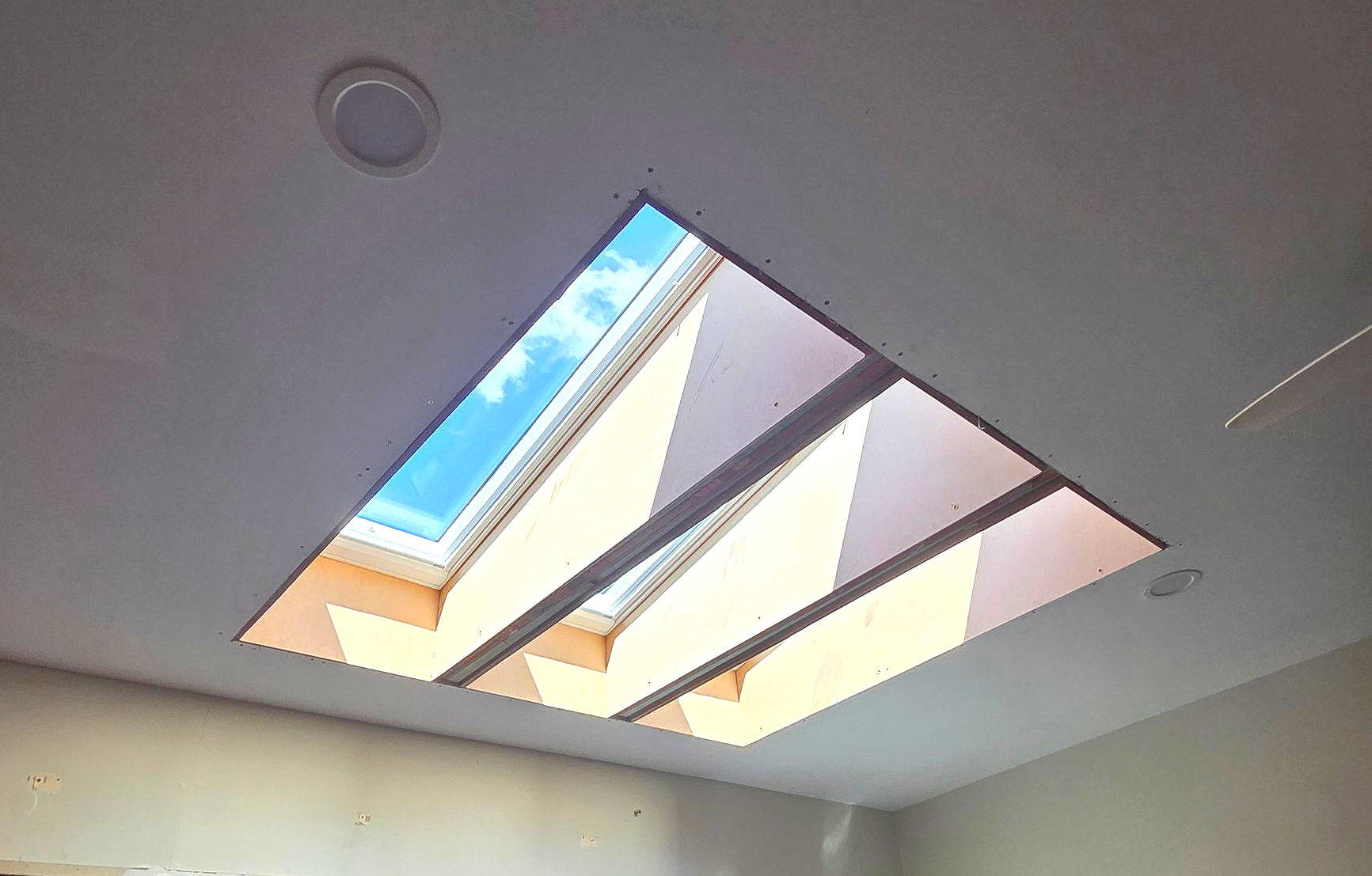 Modern Room With a Skylight, Glass Door, and Wall Art, Lit by Sunlight — Beyond Skylights in Byron Bay, NSW