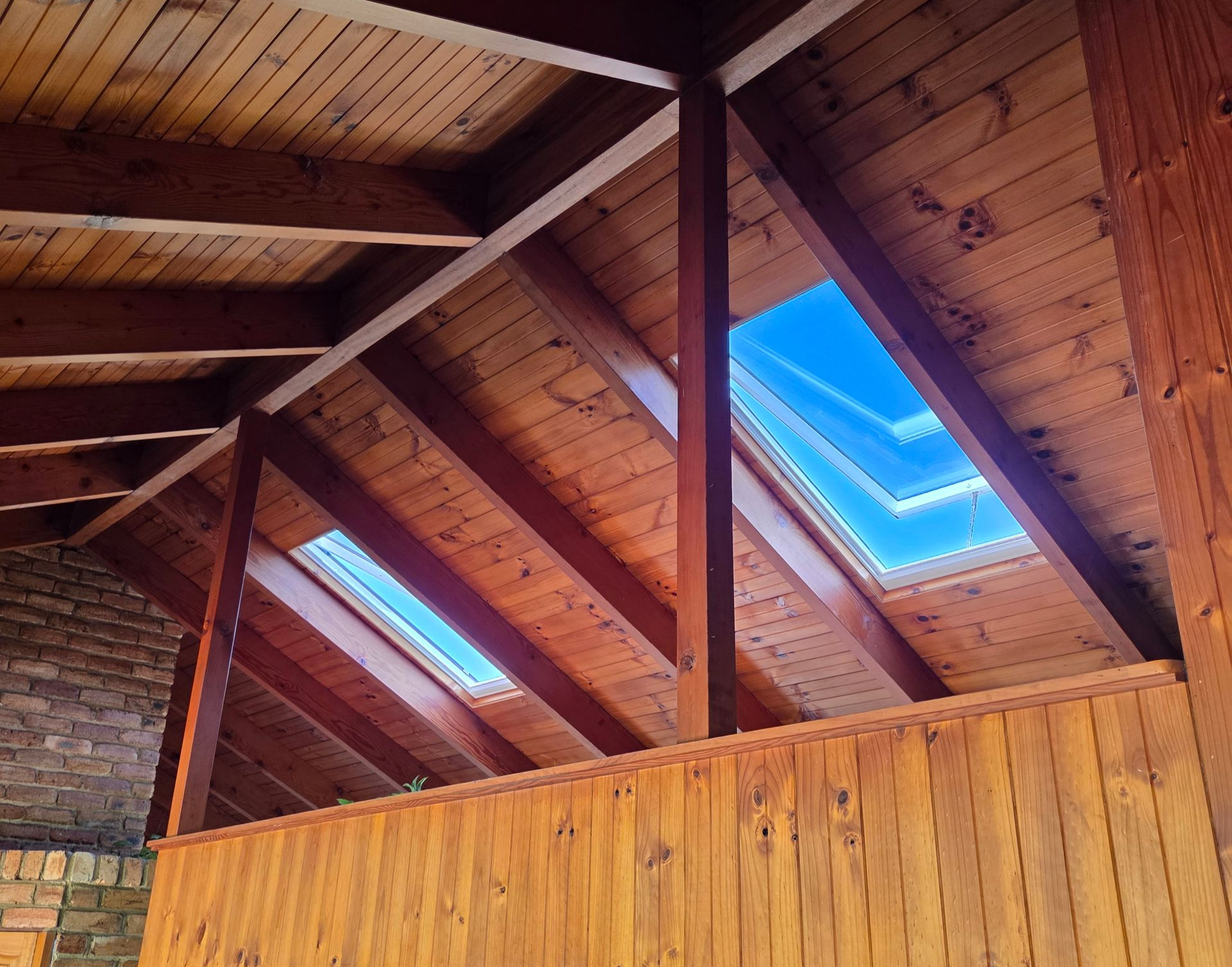 Wood-paneled Interior With Exposed Beams and Skylights Showing Blue Sky — Beyond Skylights in Byron Bay, NSW