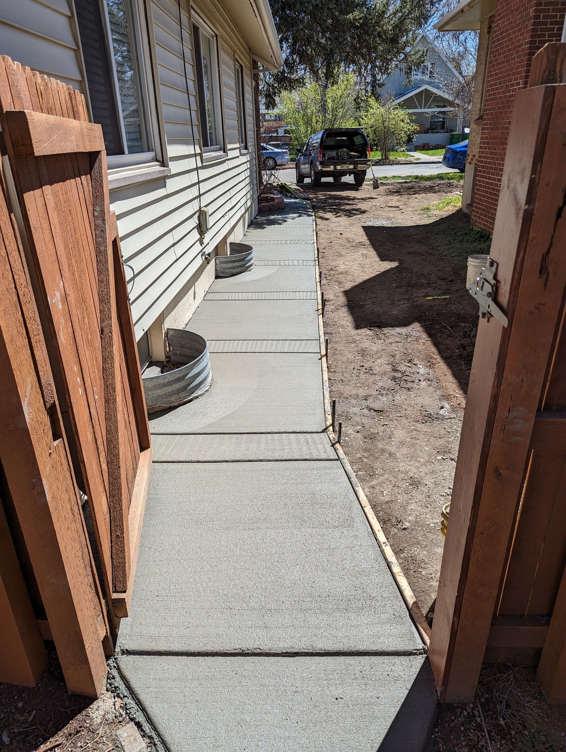 A sidewalk is being built in front of a house.