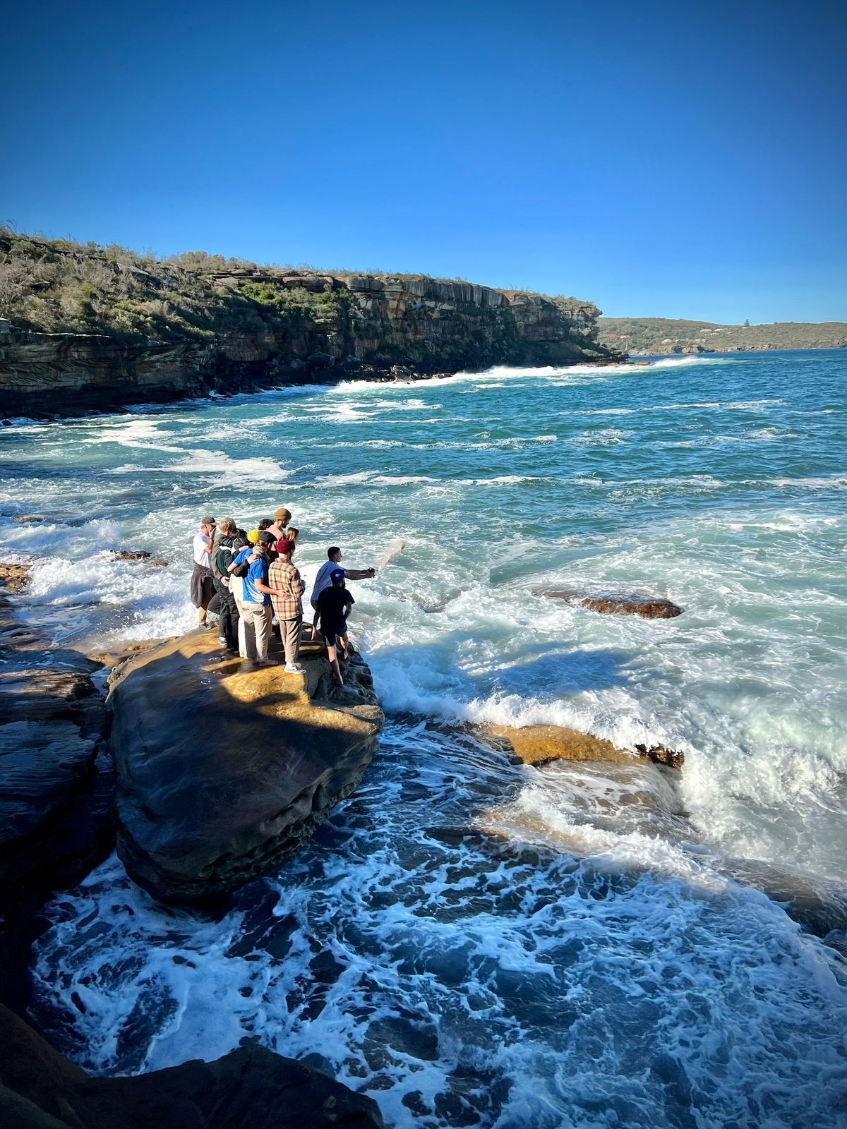 Family gathered by the coast for a memorial after cremation