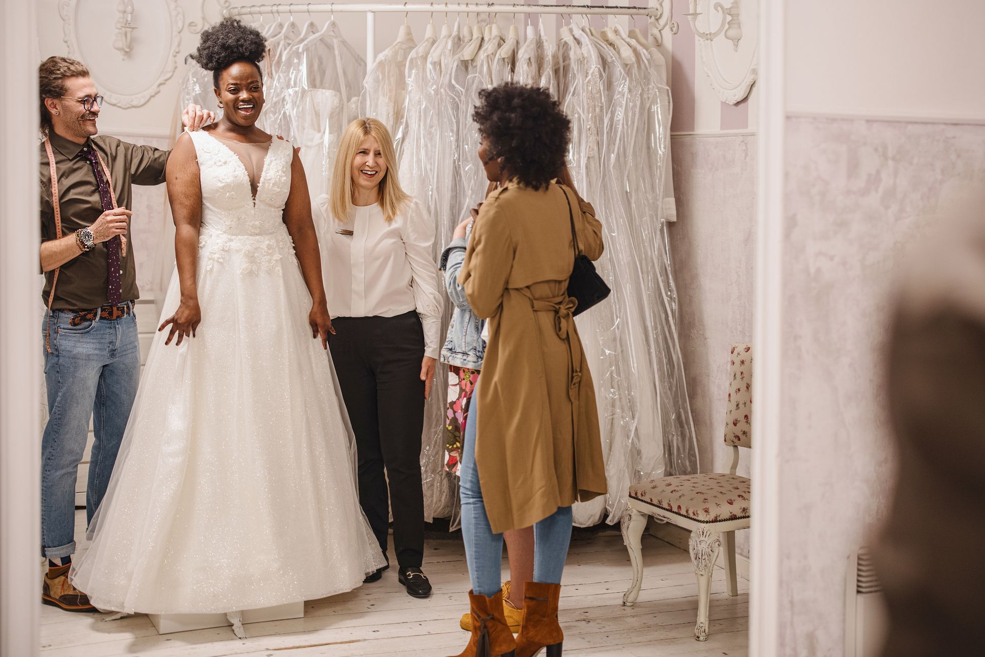 A woman is trying on a wedding dress in a bridal shop.