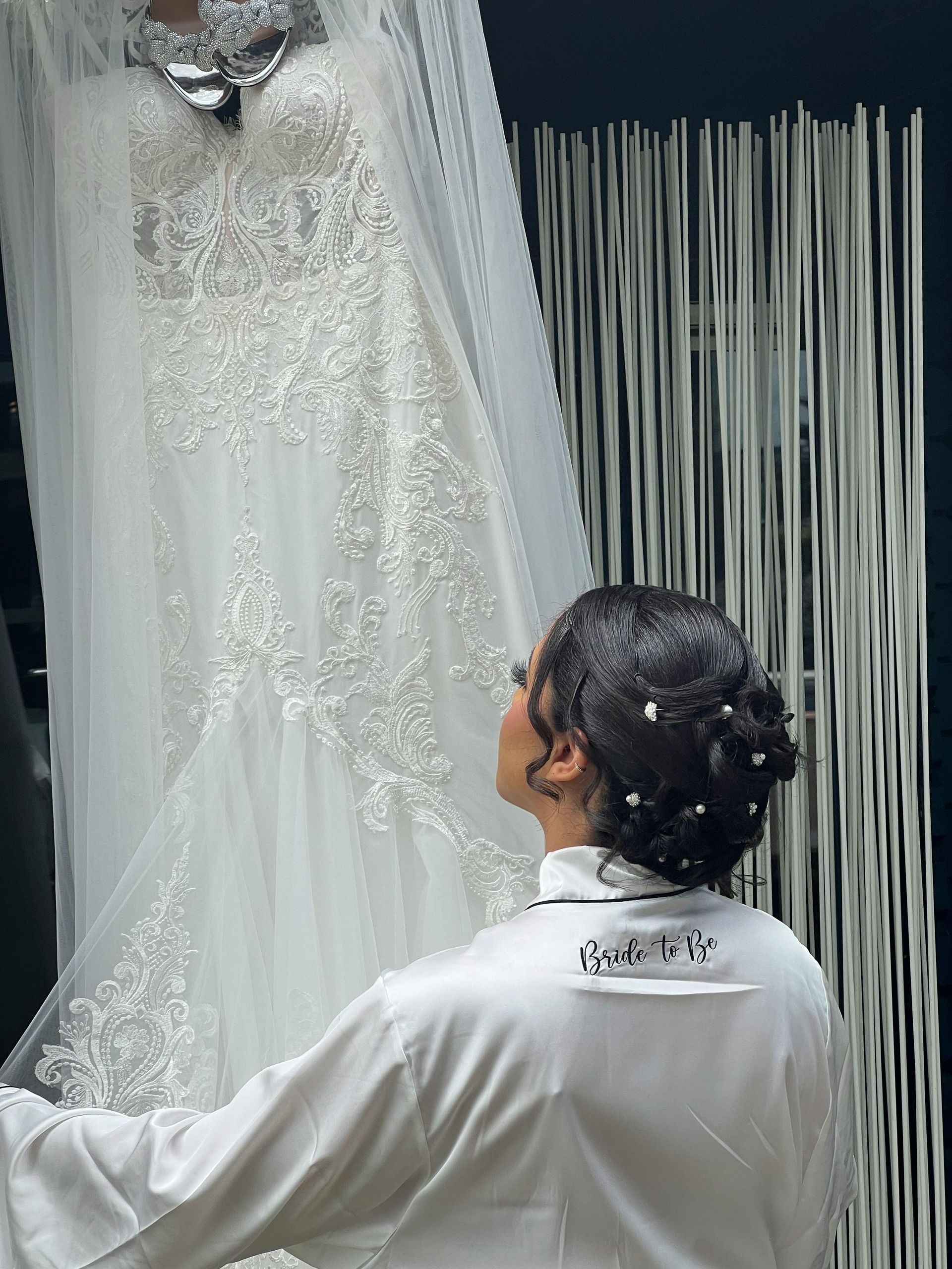 A bunch of white dresses are hanging on a rack