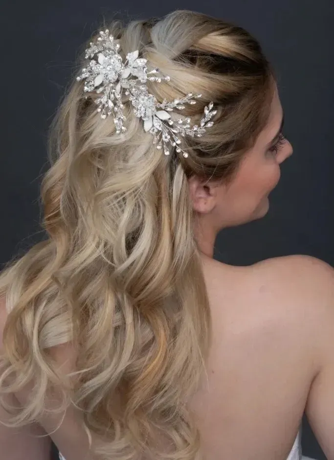 The bride is wearing a veil and a flower in her hair.