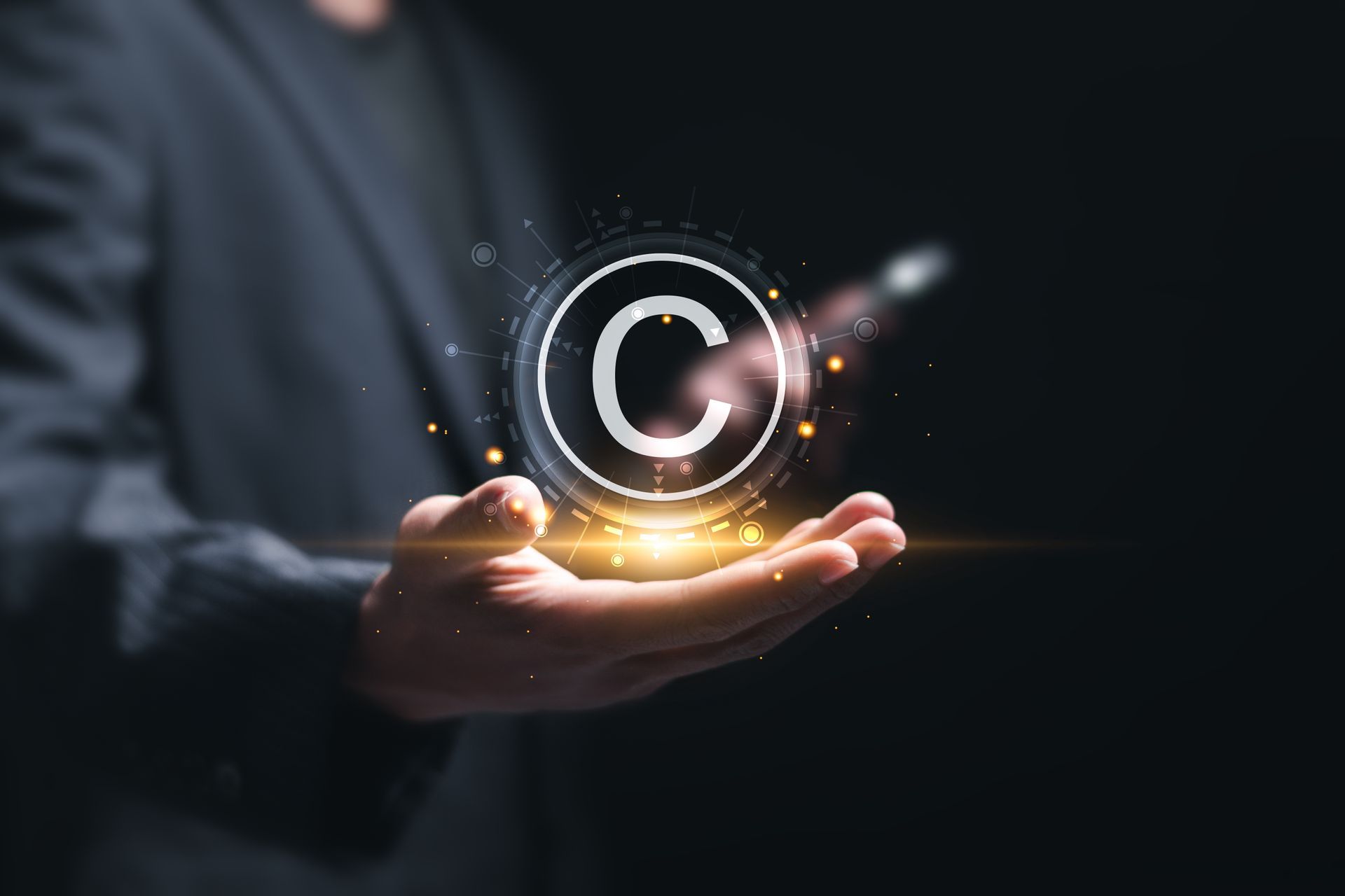 A man in a suit is holding a copyright symbol in his hands.