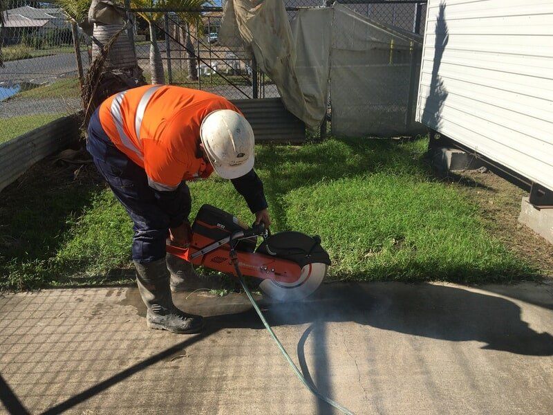 A Worker Using A High-Powered Concrete Cutter — Concrete Cutters in Capricorn Coast, QLD