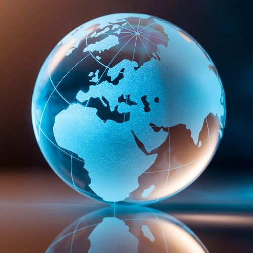 Glass globe with continents illuminated, reflecting light.