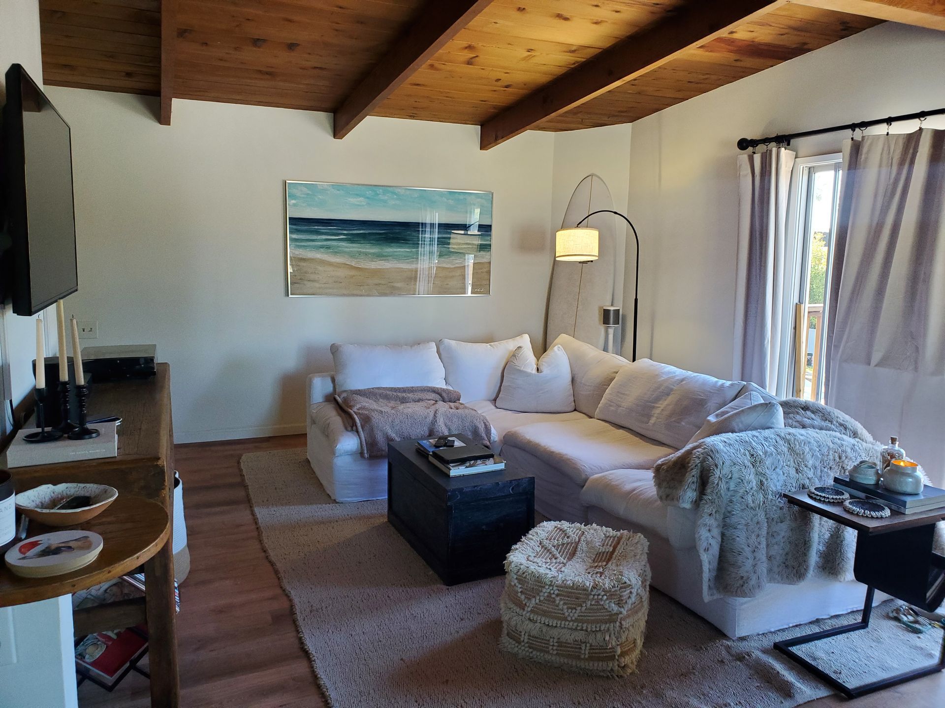 A living room with a couch , coffee table , and television.