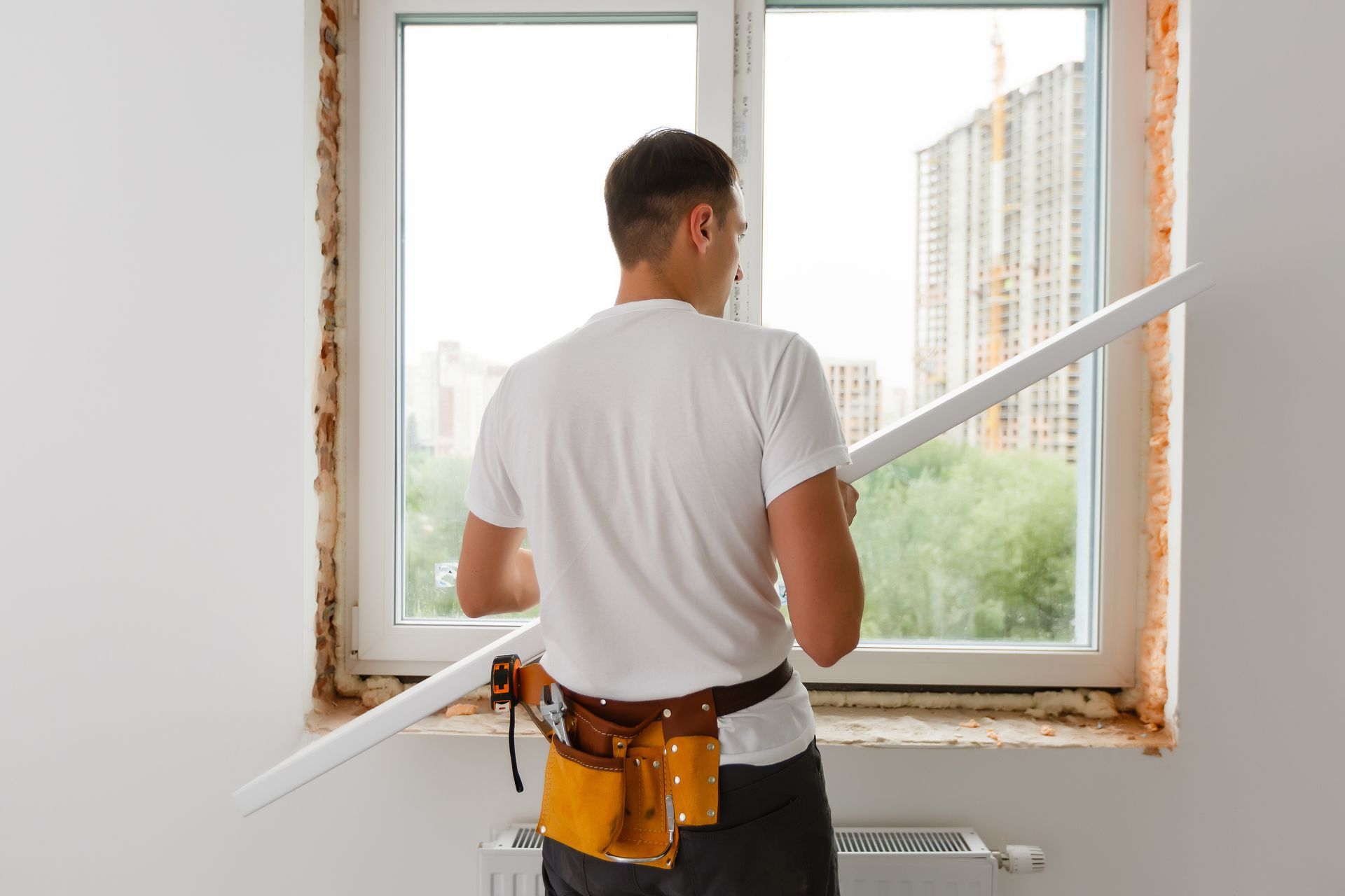 Window Installation โ Person installing trim around a window in Cranberry Township, PA