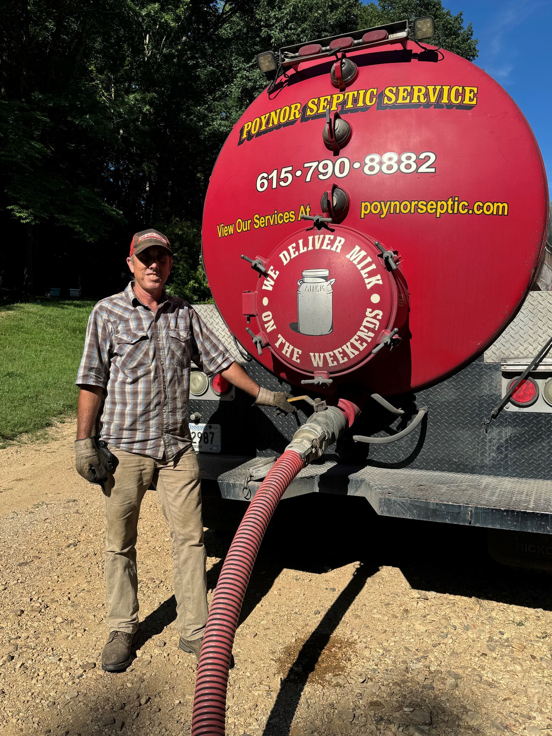 A vacuum truck is pumping water into a septic tank.