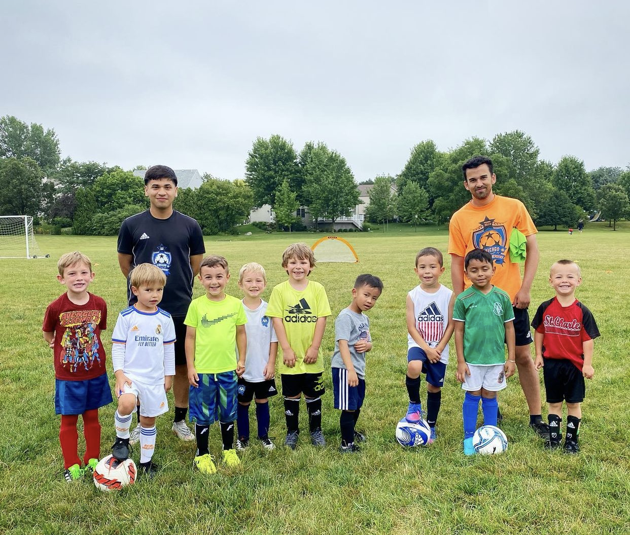 Children developing soccer footwork, field awareness, and teamwork through organized youth soccer camp activities in Elgin, IL