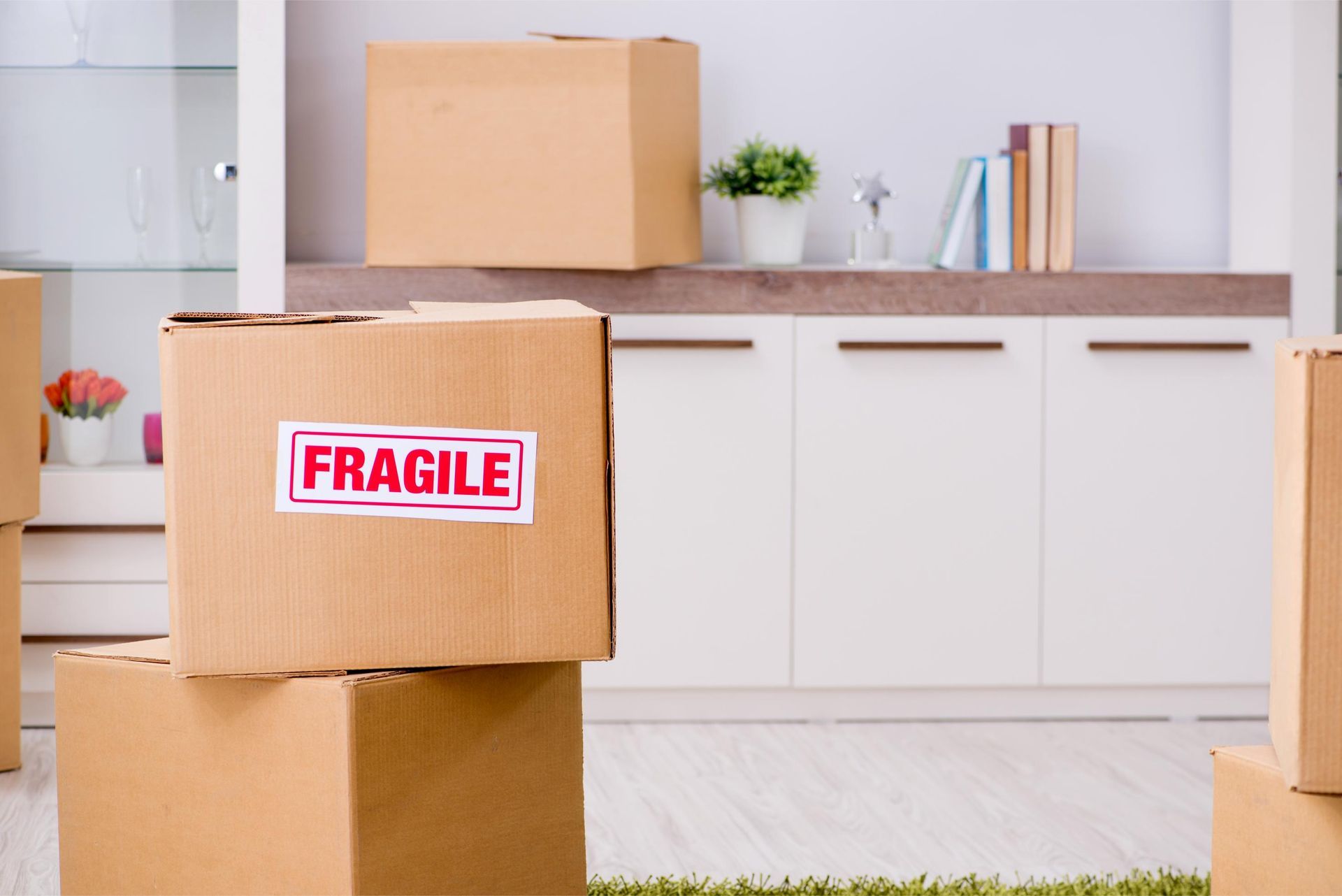 Cardboard boxes stacked, one labeled 