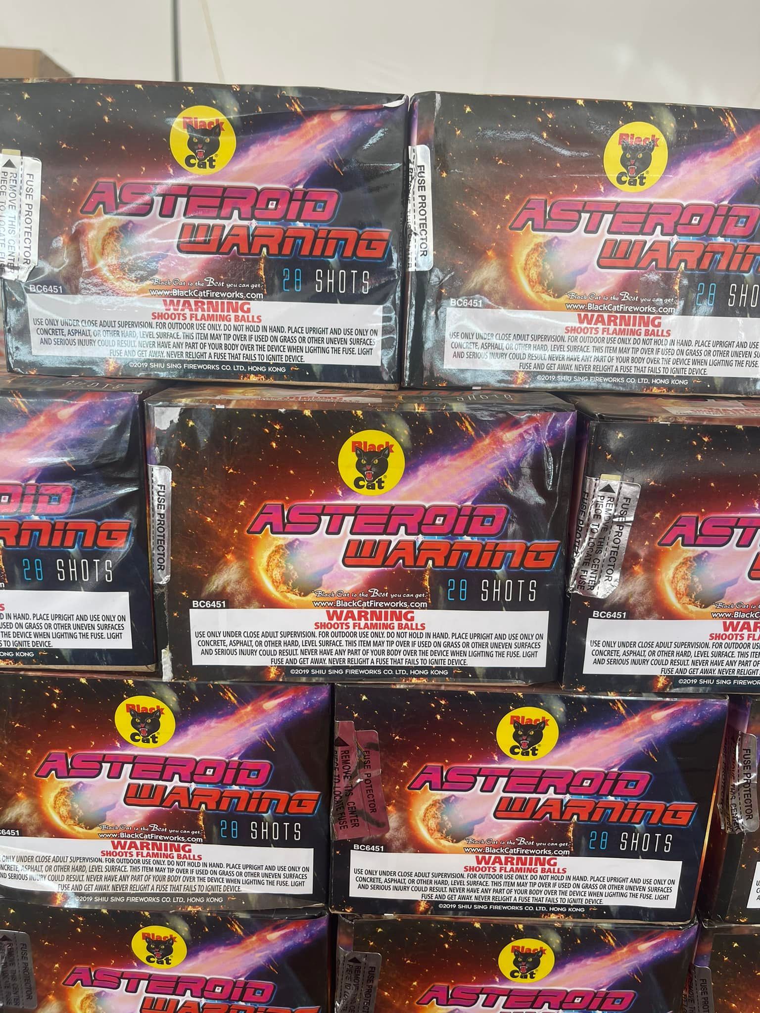 Boxes of asteroid warning fireworks are stacked on top of each other