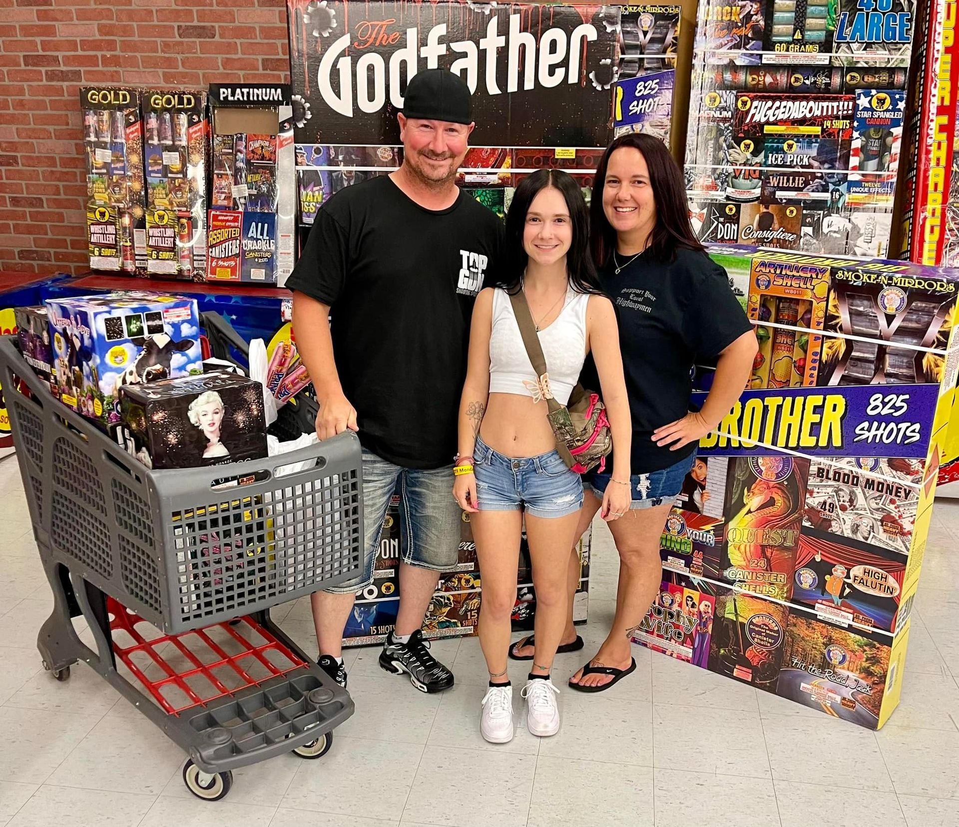 A group of people standing in front of a godfather sign
