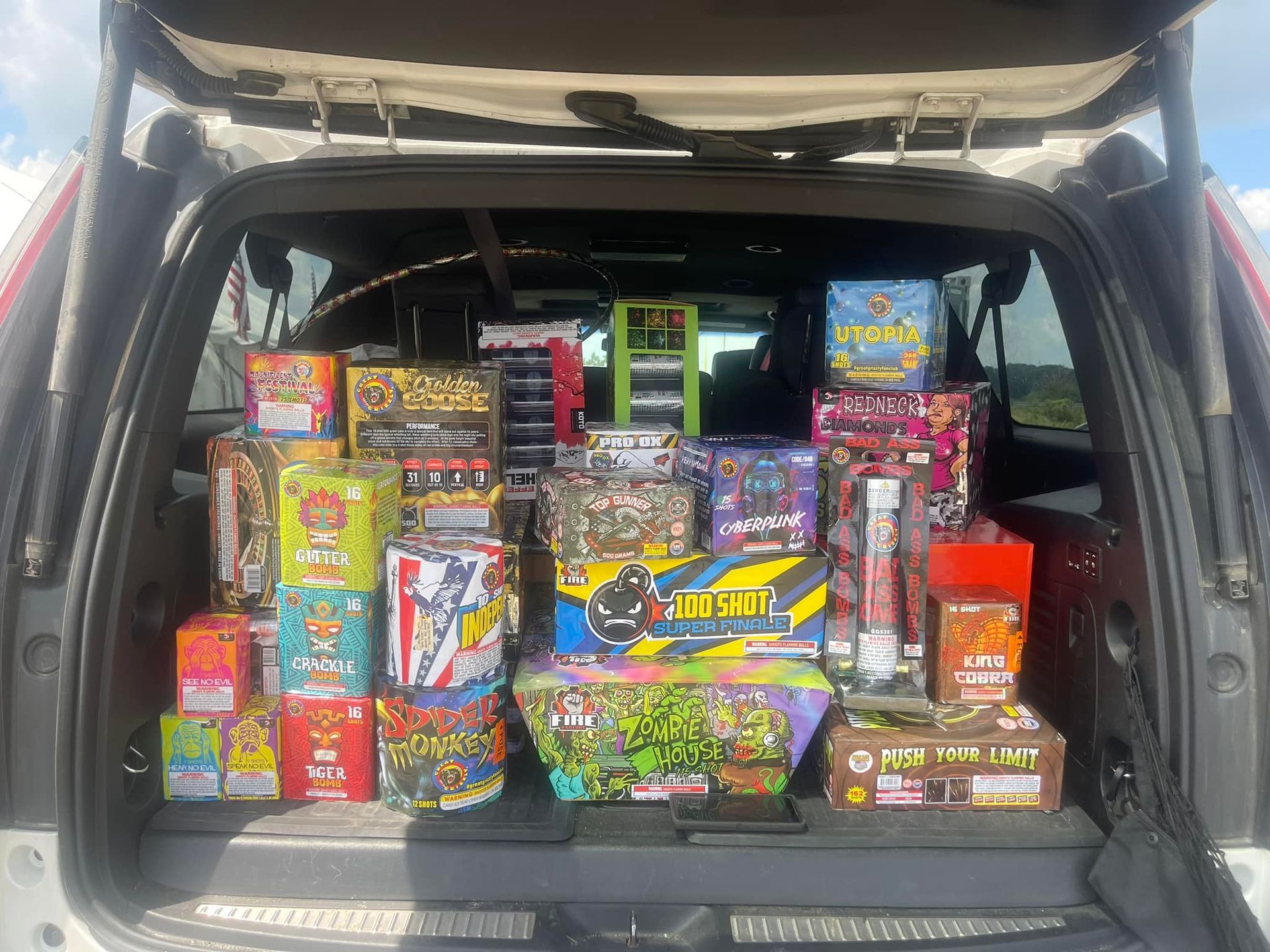 The back of a car filled with lots of fireworks.