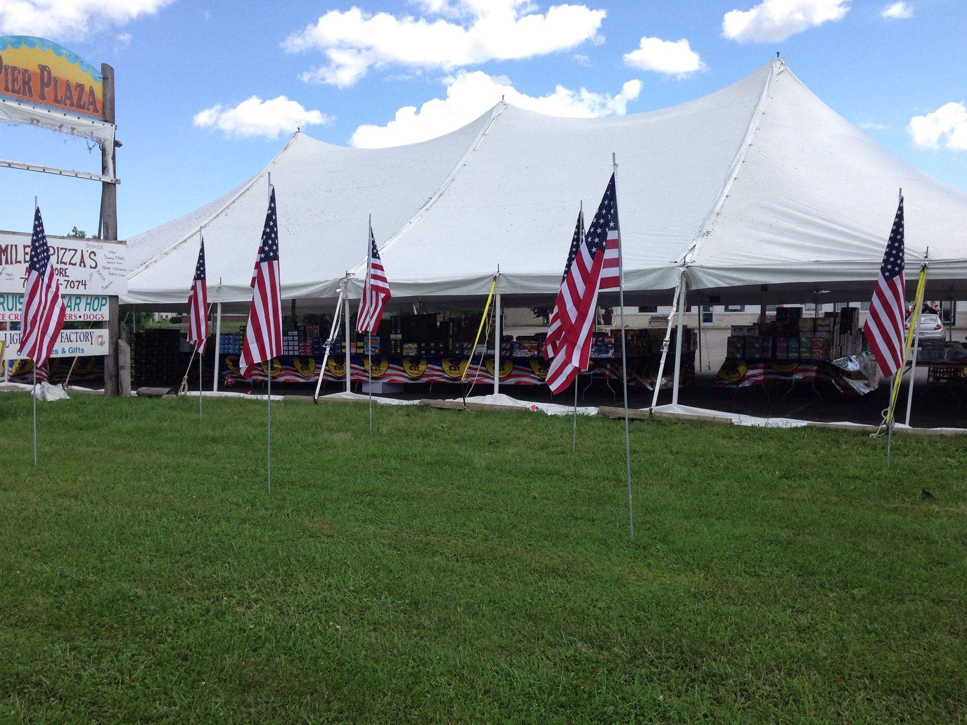 A large white tent with american flags in front of it