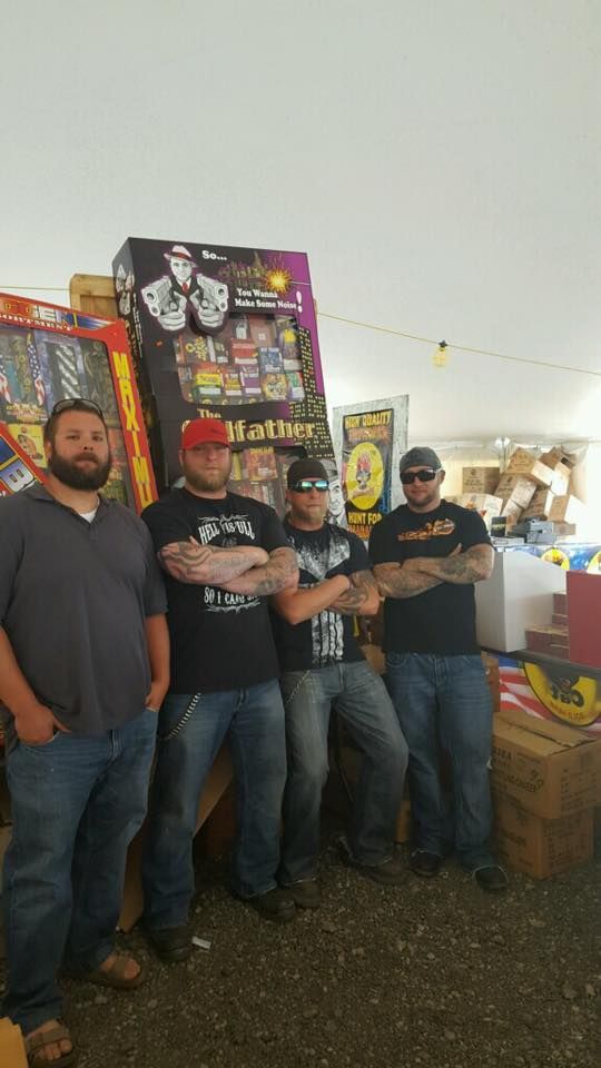 A group of men are standing next to each other in front of a machine.