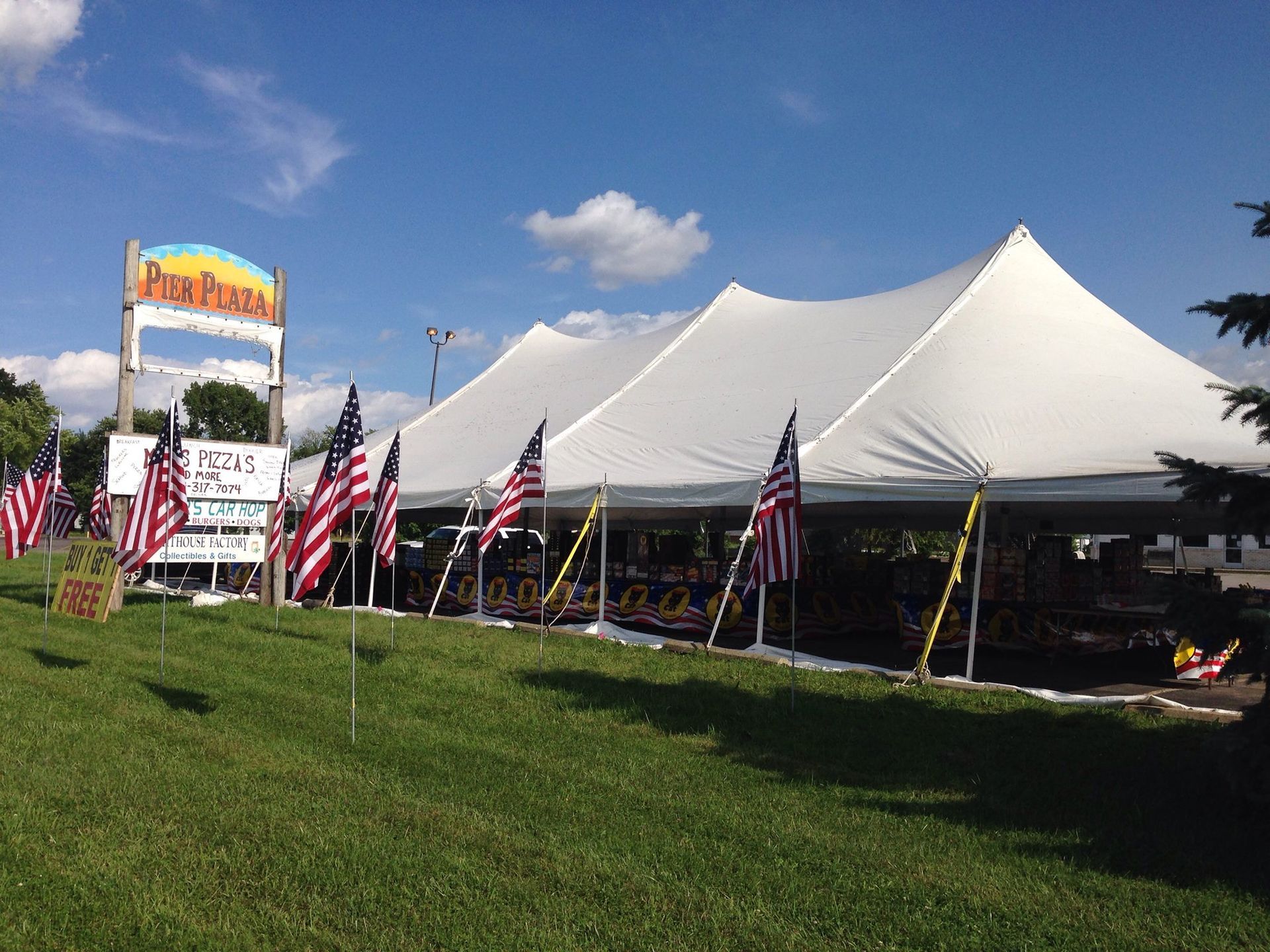 A large white tent with american flags in front of it