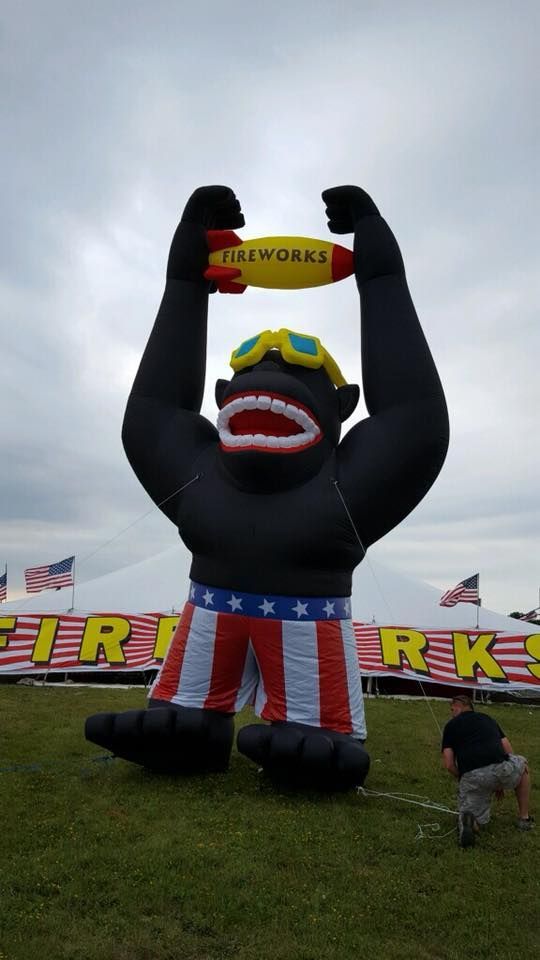 A large inflatable gorilla holding a fireworks rocket