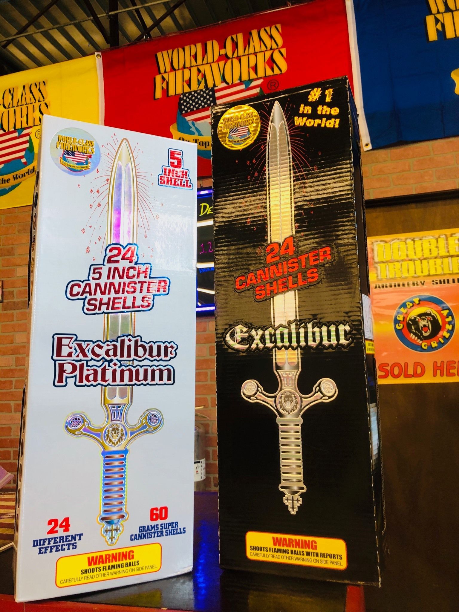 A box of excalibur fireworks sits next to a box of excalibur platinum fireworks