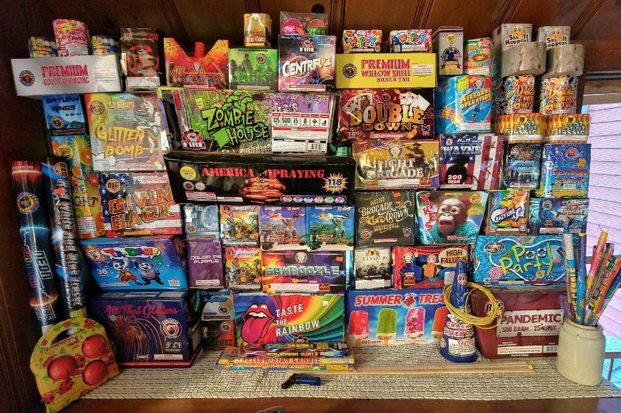 A shelf filled with lots of different types of fireworks.