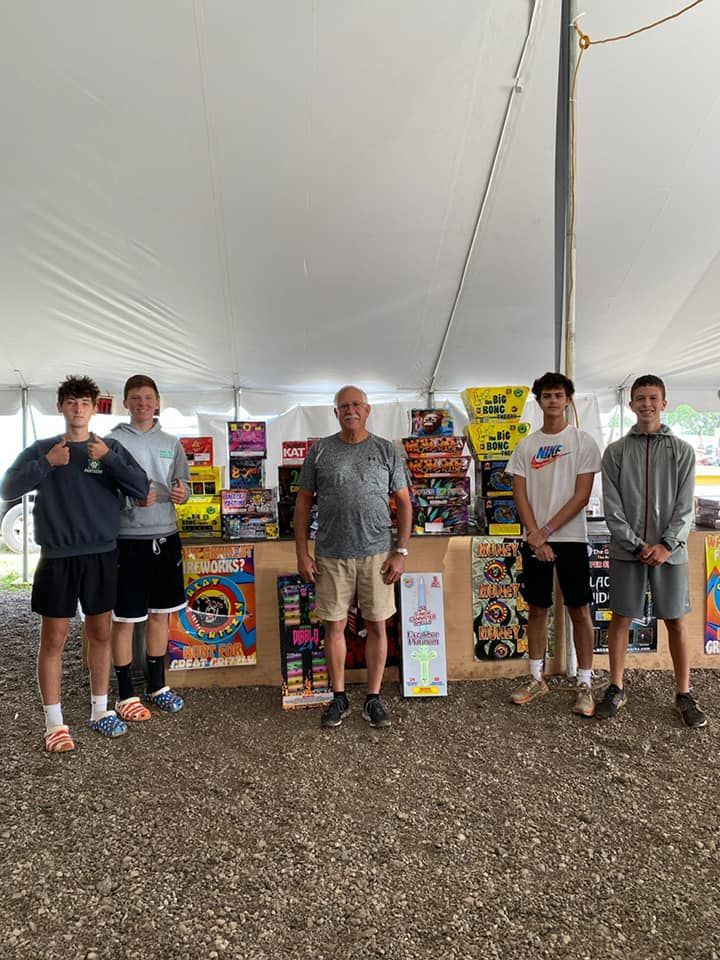 A group of young men are standing in front of a tent.
