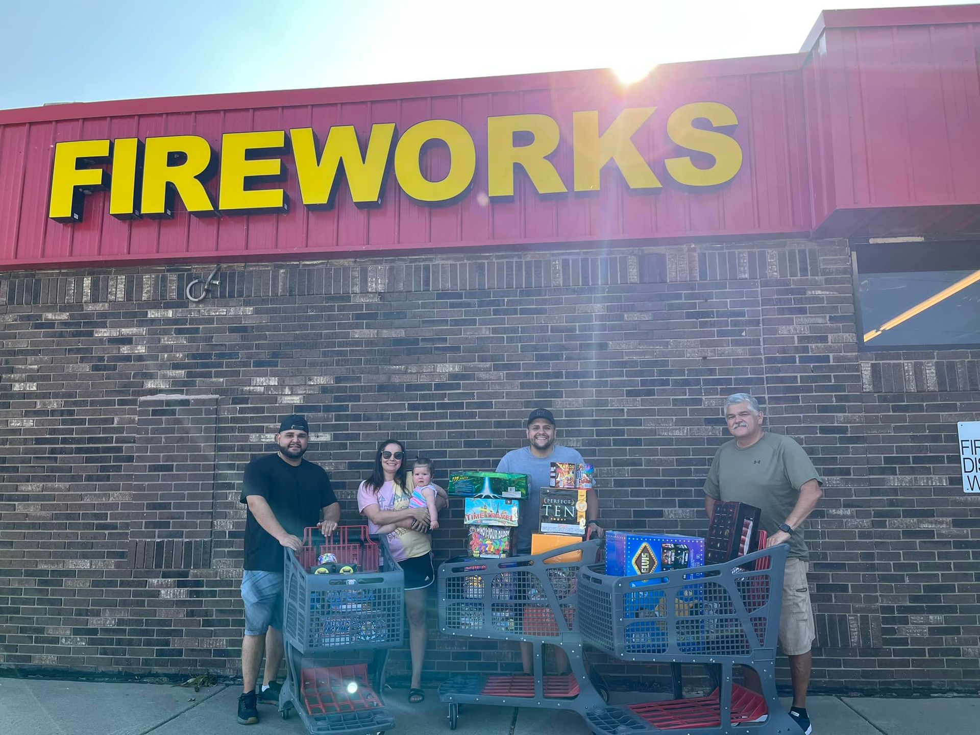 A group of people are standing in front of a fireworks store.